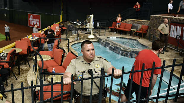 Oct 9, 2017; Phoenix, AZ, USA; Police and venue security guard the pool area following the Los Angeles Dodgers victory against the Arizona Diamondbacks in game three of the 2017 NLDS playoff baseball series at Chase Field. Mandatory Credit: Matt Kartozian-USA TODAY Sports